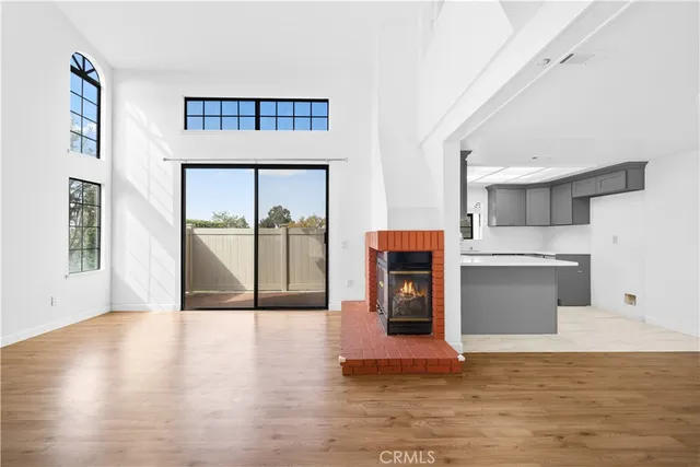 a kitchen with a sink cabinets and wooden floor