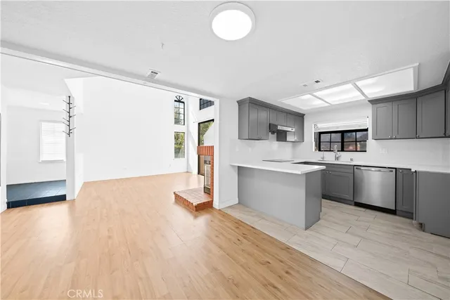 a view of empty room with wooden floor and cabinet