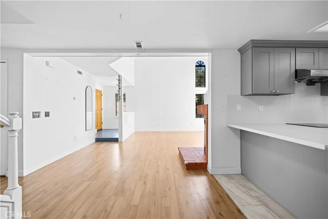 a kitchen with stainless steel appliances granite countertop a refrigerator and a stove top oven