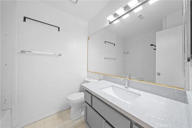 a view of a hallway with wooden floor and windows