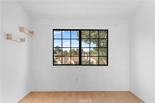 an empty room with windows and closet