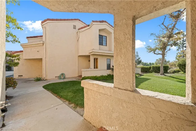 an entryway with wooden floor and windows