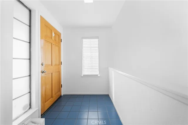 a view of empty room with wooden floor and a floor to ceiling window
