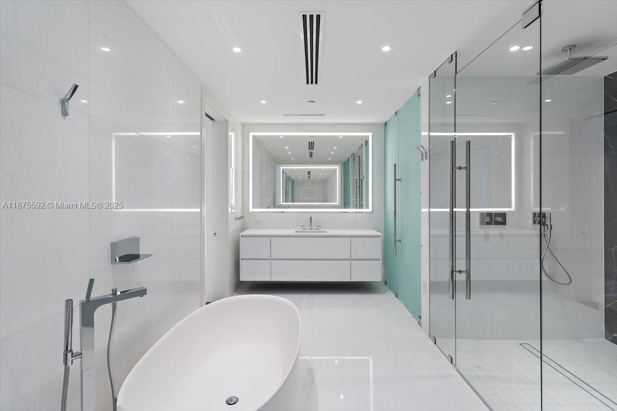 300 Biscayne Blvd Way, Unit 5002 Miami, FL 33131 - Photo 38 of 69 a bathroom with a tub and a shower