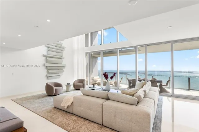 a living room with furniture a rug and a table