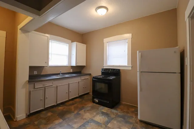 a kitchen with a refrigerator and a sink