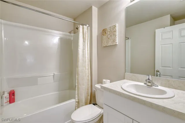 a bedroom with a large bed and a painting on the wall