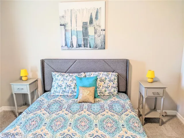 a bed sitting in a bedroom next to a window