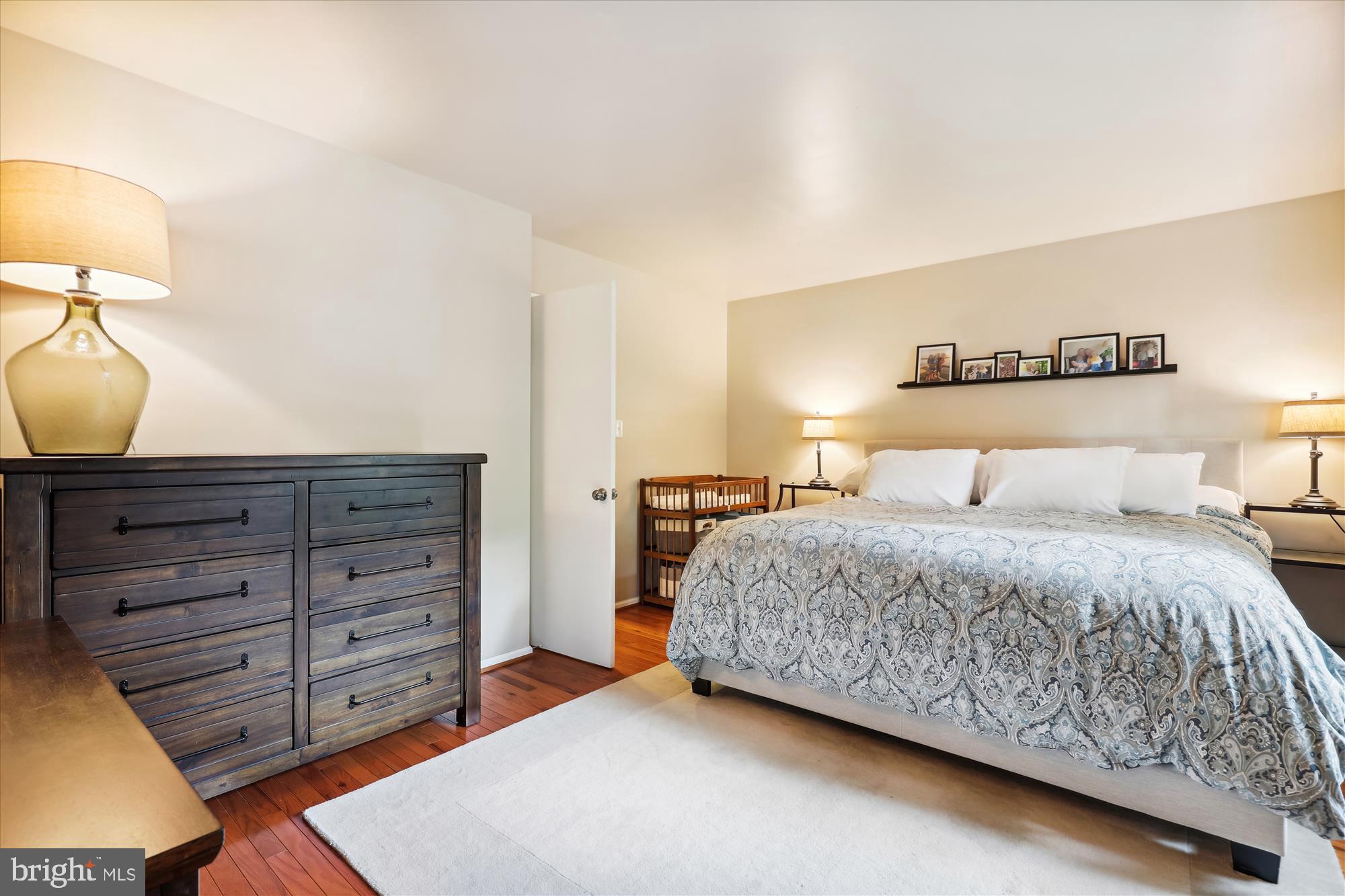 8322 Riverside Road Alexandria, VA 22308 - Photo 13 of 38 a bedroom with a bed and a night stand