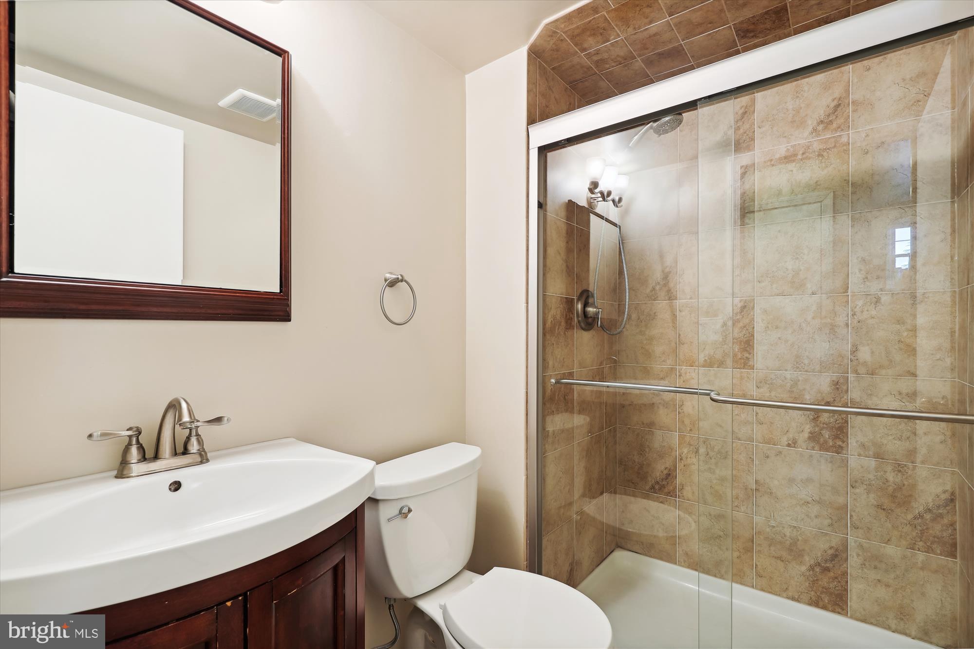 8322 Riverside Road Alexandria, VA 22308 - Photo 24 of 38 a bathroom with a sink and mirror with toilet