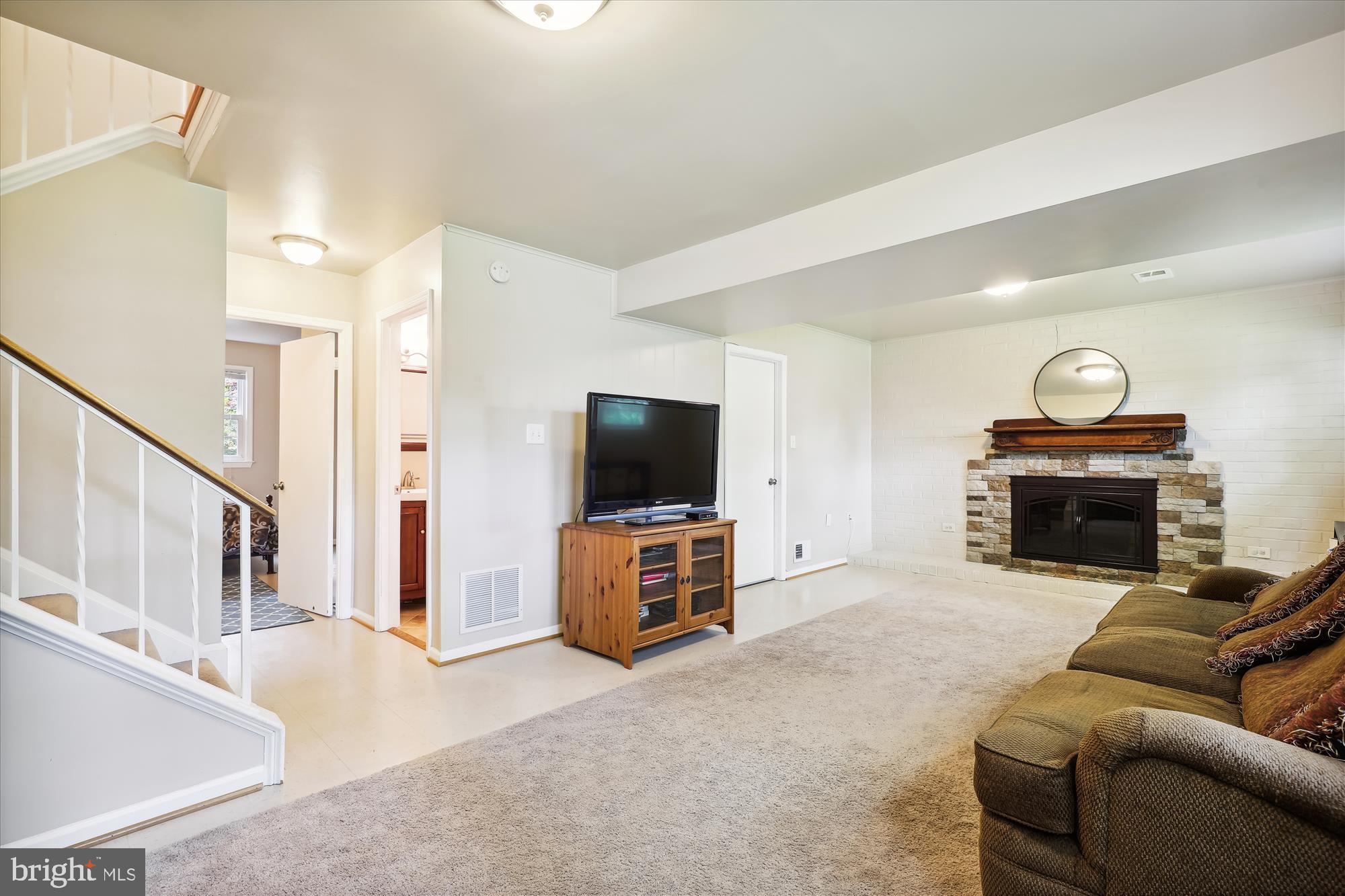 8322 Riverside Road Alexandria, VA 22308 - Photo 26 of 38 a living room with furniture and a flat screen tv
