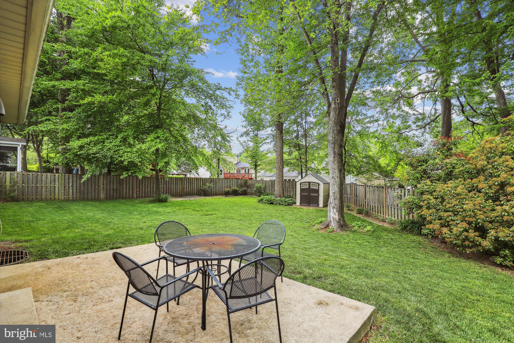 8322 Riverside Road Alexandria, VA 22308 - Photo 30 of 38 a view of a backyard with table and chairs potted plants and large tree