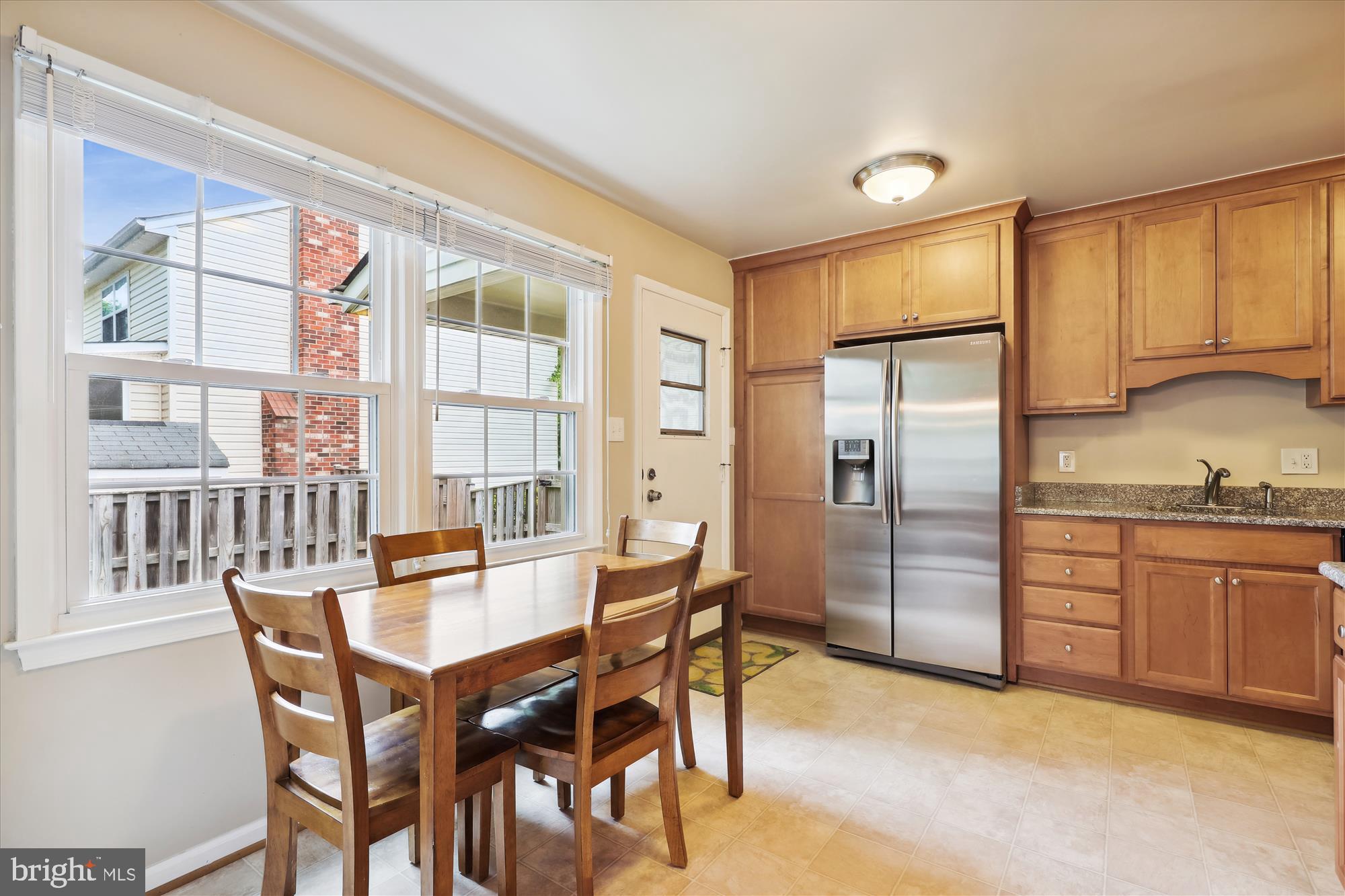 8322 Riverside Road Alexandria, VA 22308 - Photo 8 of 38 a kitchen with stainless steel appliances granite countertop a refrigerator a sink a stove and a dining table with wooden cabinet