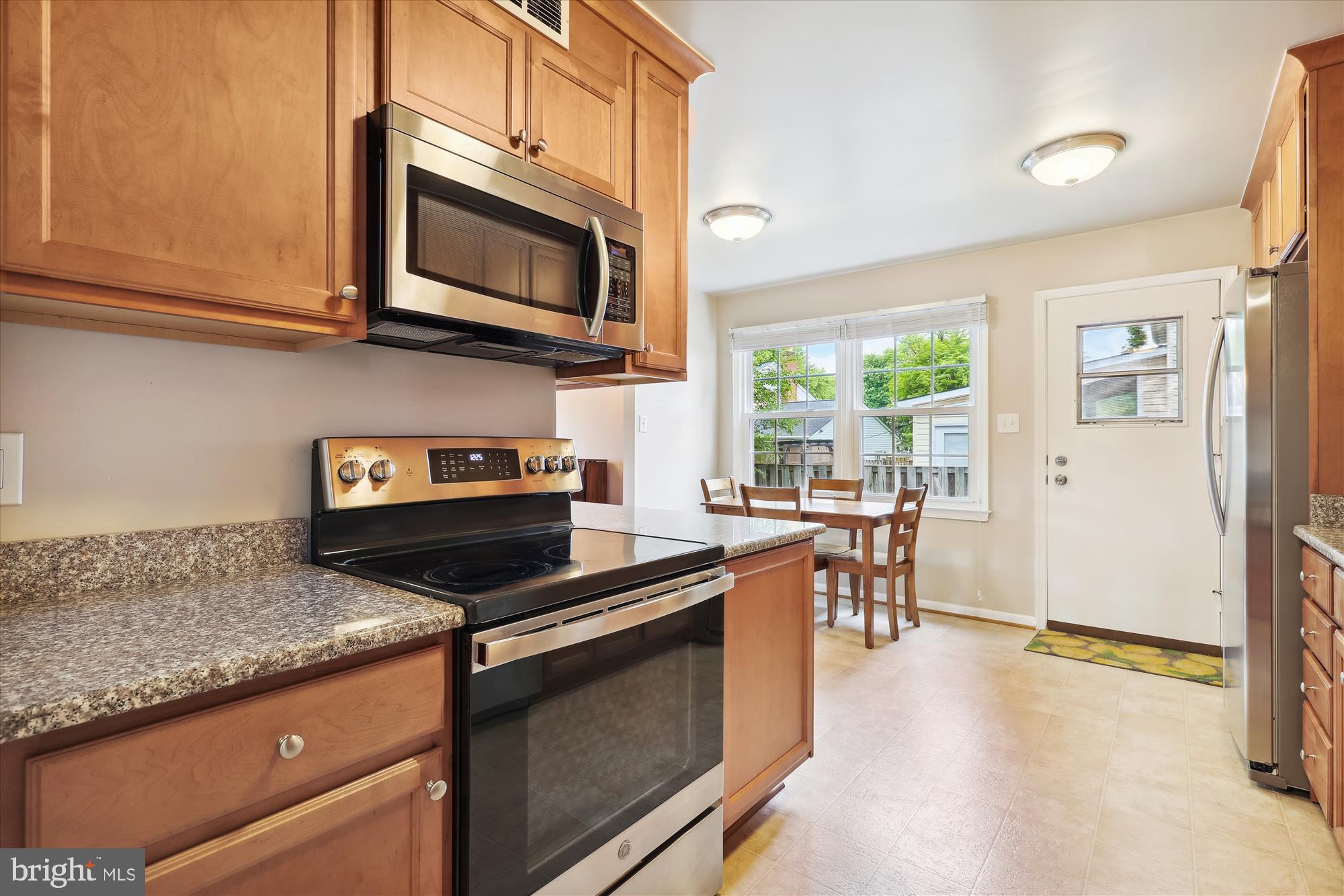 8322 Riverside Road Alexandria, VA 22308 - Photo 10 of 38 a kitchen with stainless steel appliances granite countertop a stove microwave and sink