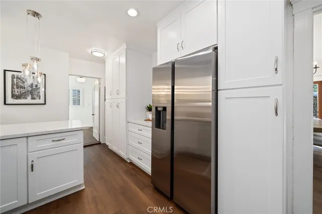 a kitchen with cabinets and stainless steel appliances