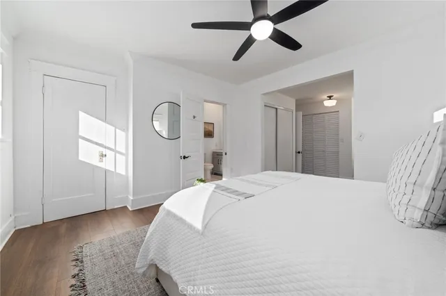 a spacious bedroom with a bed and a chandelier