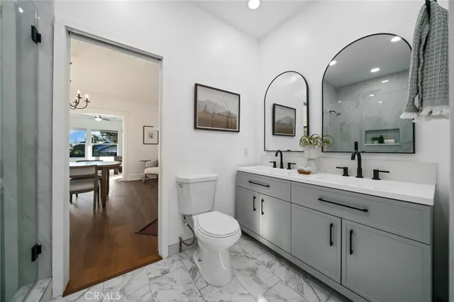 a spacious bathroom with a toilet sink and mirror
