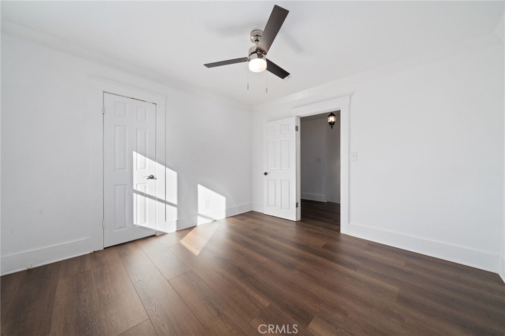 1148 Chestnut Avenue Long Beach, CA 90813 - Photo 26 of 32 an empty room with wooden floor a ceiling fan and windows