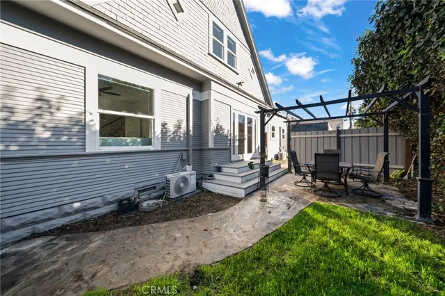 a view of a house with backyard and sitting area