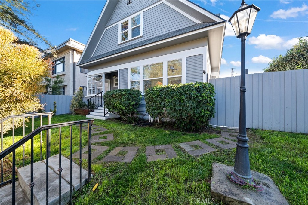 1148 Chestnut Avenue Long Beach, CA 90813 - Photo 4 of 32 a view of a house with brick walls plants and large tree