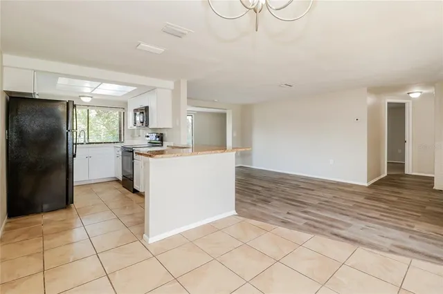 a kitchen with stainless steel appliances a refrigerator sink and cabinets