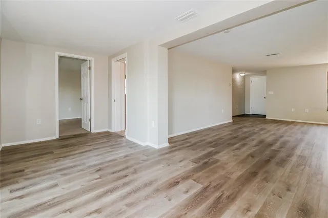 a view of an empty room and wooden floor