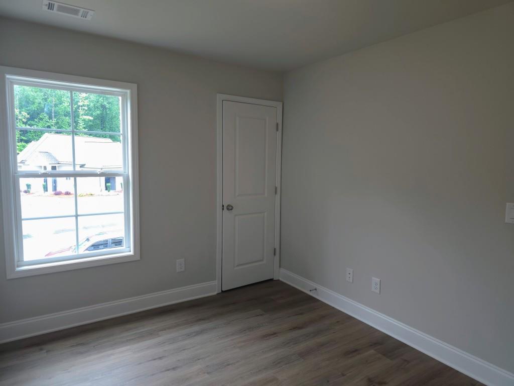 4240 Cavalier Way Duluth, GA 30097 - Photo 20 of 46 an empty room with wooden floor and windows