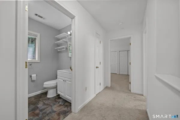 a spacious bathroom with a toilet sink and a shower