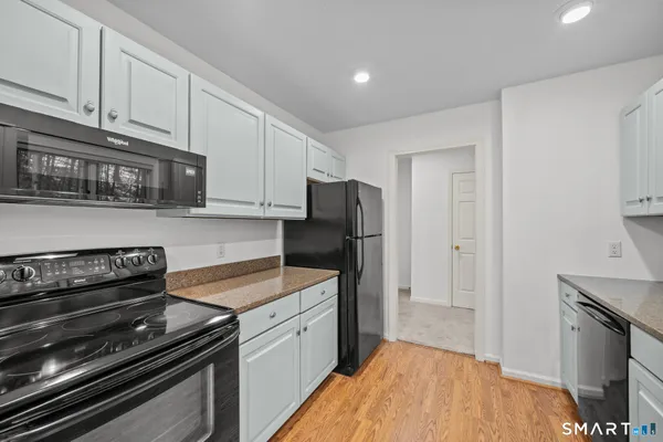 a kitchen with a stove and a refrigerator
