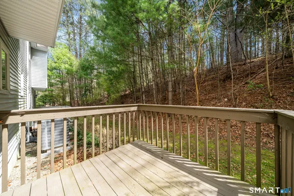 a view of balcony with wooden floor and fence