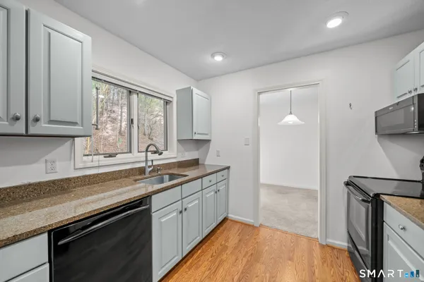 a kitchen with a sink stove and cabinets