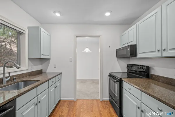 a kitchen with a sink a stove and cabinets
