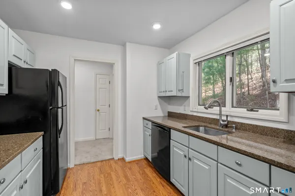a kitchen that has a sink a refrigerator and a sink