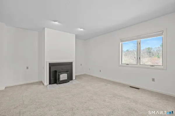 a view of empty room with a fireplace