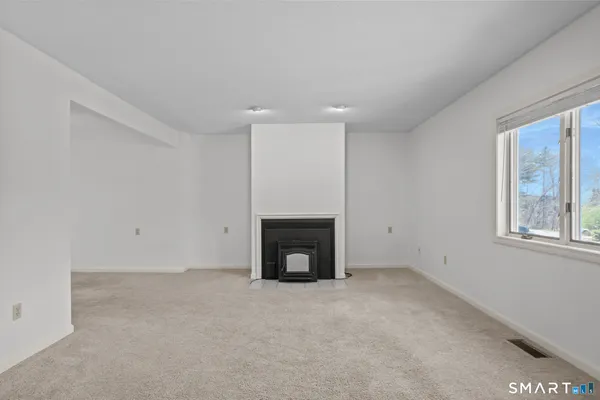 a view of an empty room with a fireplace