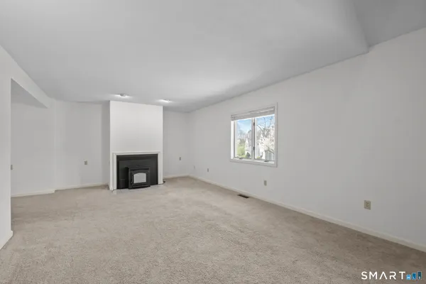 a view of empty room with a fireplace