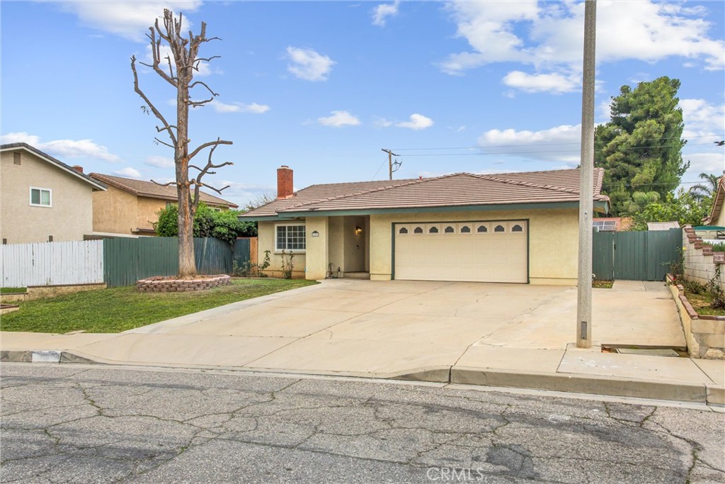 22246 Cardinal Street Grand Terrace, CA 92313 - Photo 2 of 28 a front view of a house with a yard and garage