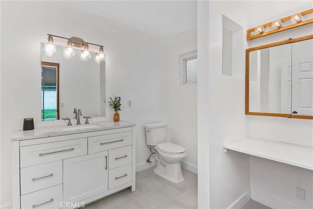 22246 Cardinal Street Grand Terrace, CA 92313 - Photo 21 of 28 a bathroom with a toilet sink and mirror