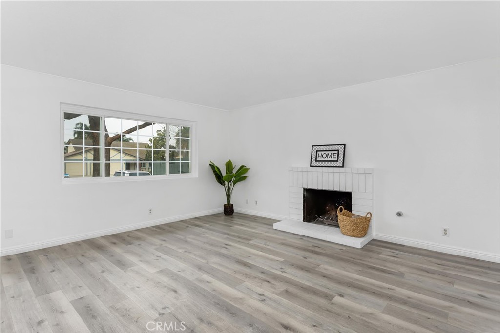 22246 Cardinal Street Grand Terrace, CA 92313 - Photo 5 of 28 a view of empty room with wooden floor and window