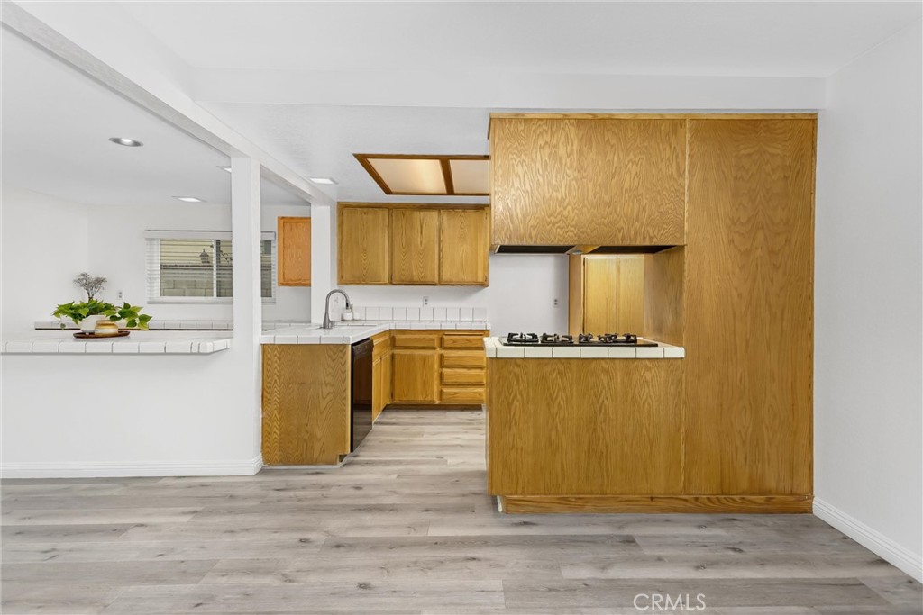 22246 Cardinal Street Grand Terrace, CA 92313 - Photo 10 of 28 a kitchen with stainless steel appliances granite countertop a sink cabinets and wooden floor