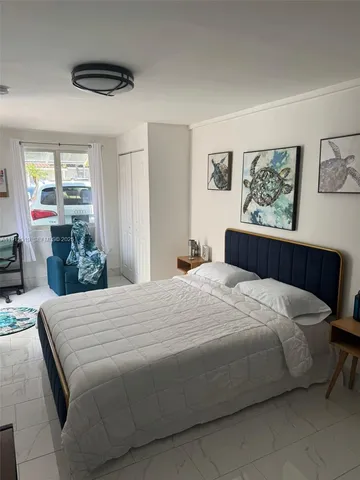 a bedroom with a bed and walk in closet