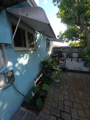 an outdoor space with seating area and trees