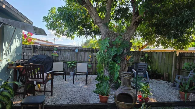 an outdoor space with seating area and trees