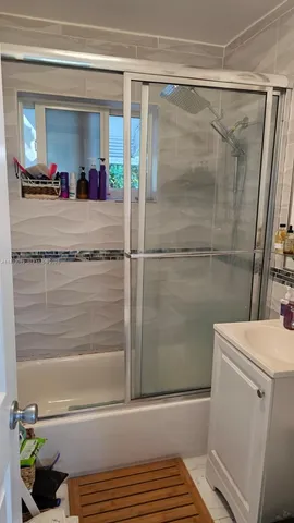 a bathroom with a shower and a sink