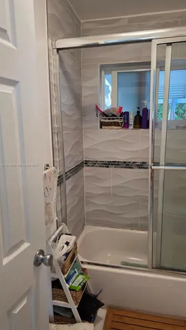 a bathroom with a shower and a sink