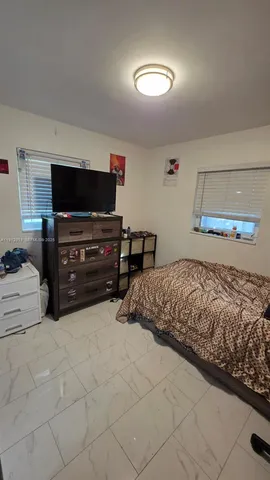 a bedroom with a bed and dresser