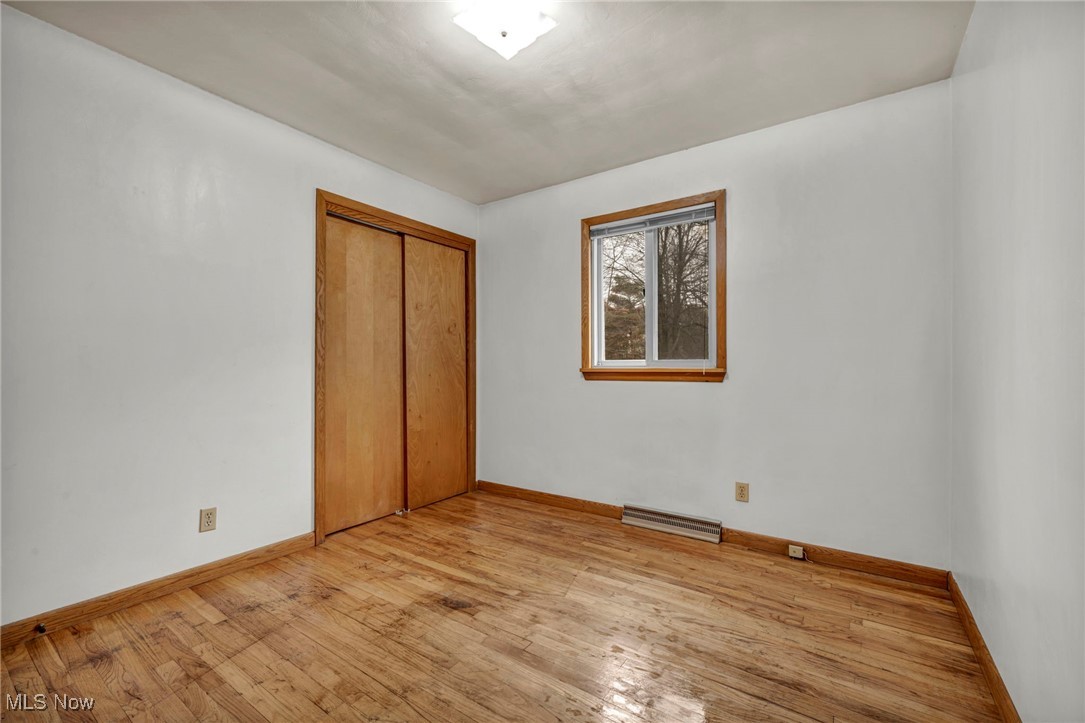 1140 Keefer Road Girard, OH 44420 - Photo 16 of 49 Unfurnished bedroom featuring light wood-style floors and a closet