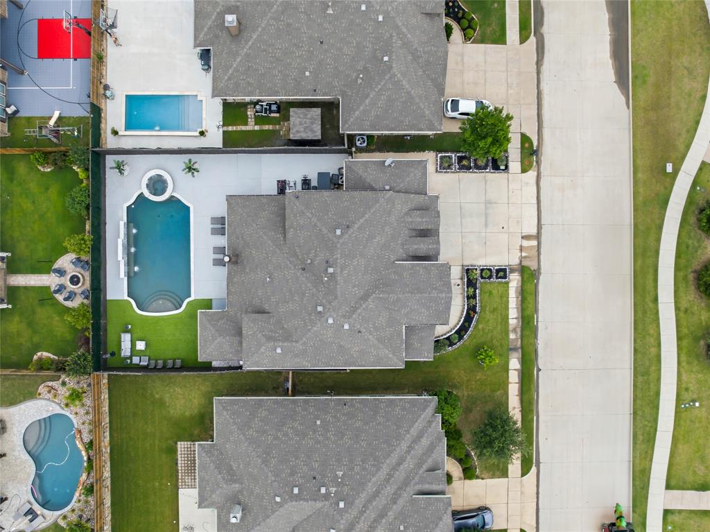 1802 Roundtree Road Forney, TX 75126 - Photo 5 of 39 an aerial view of a house with a garden and swimming pool