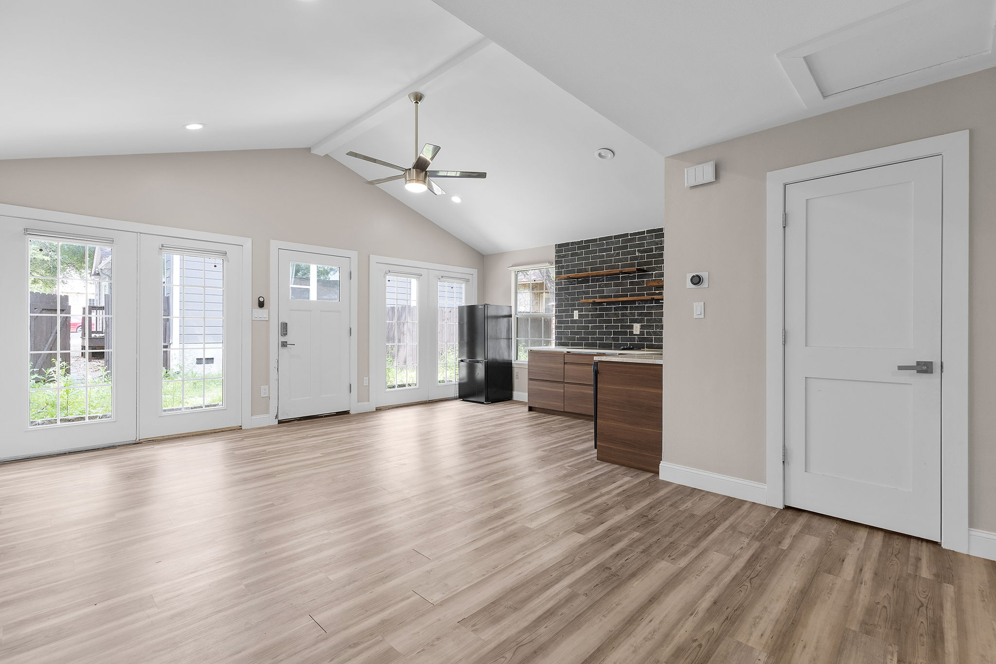 3909 Willbert Road, Unit B Austin, TX 78751 - Photo 7 of 16 Open living area with vaulted ceilings and wood-look vinyl flooring