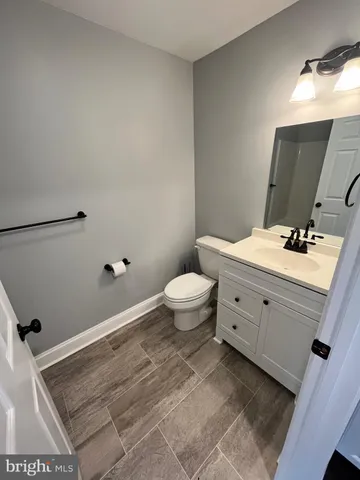a bathroom with a sink toilet and mirror